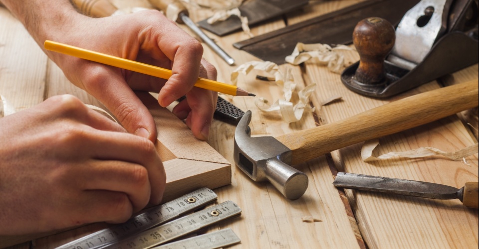 carpenter working,hammer,meter and screw-driver on construction background